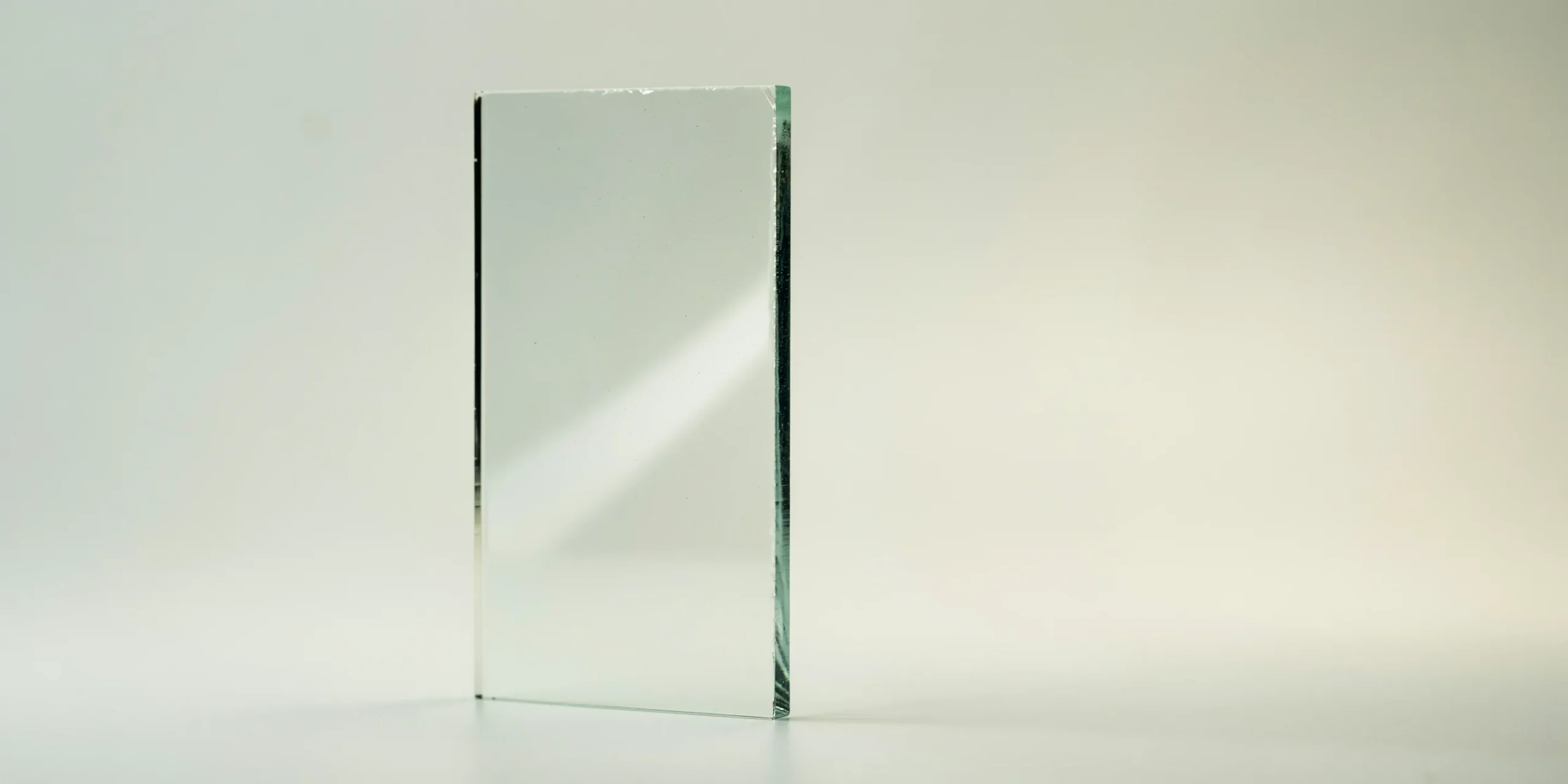 Artistic representation of architectural glass showing transparency and reflections.