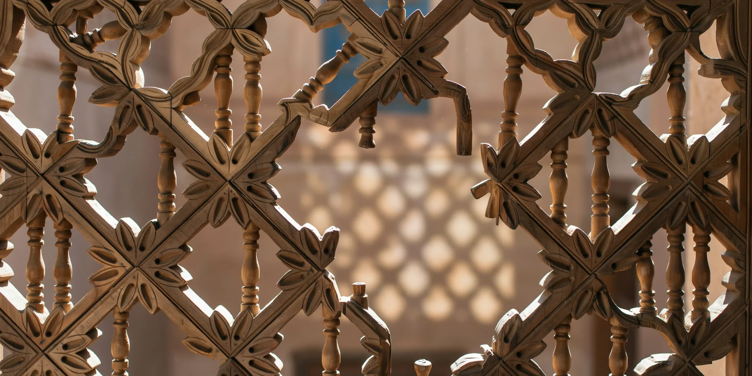 Intricate mashrabiya screen demonstrating filtered light in vernacular architecture.