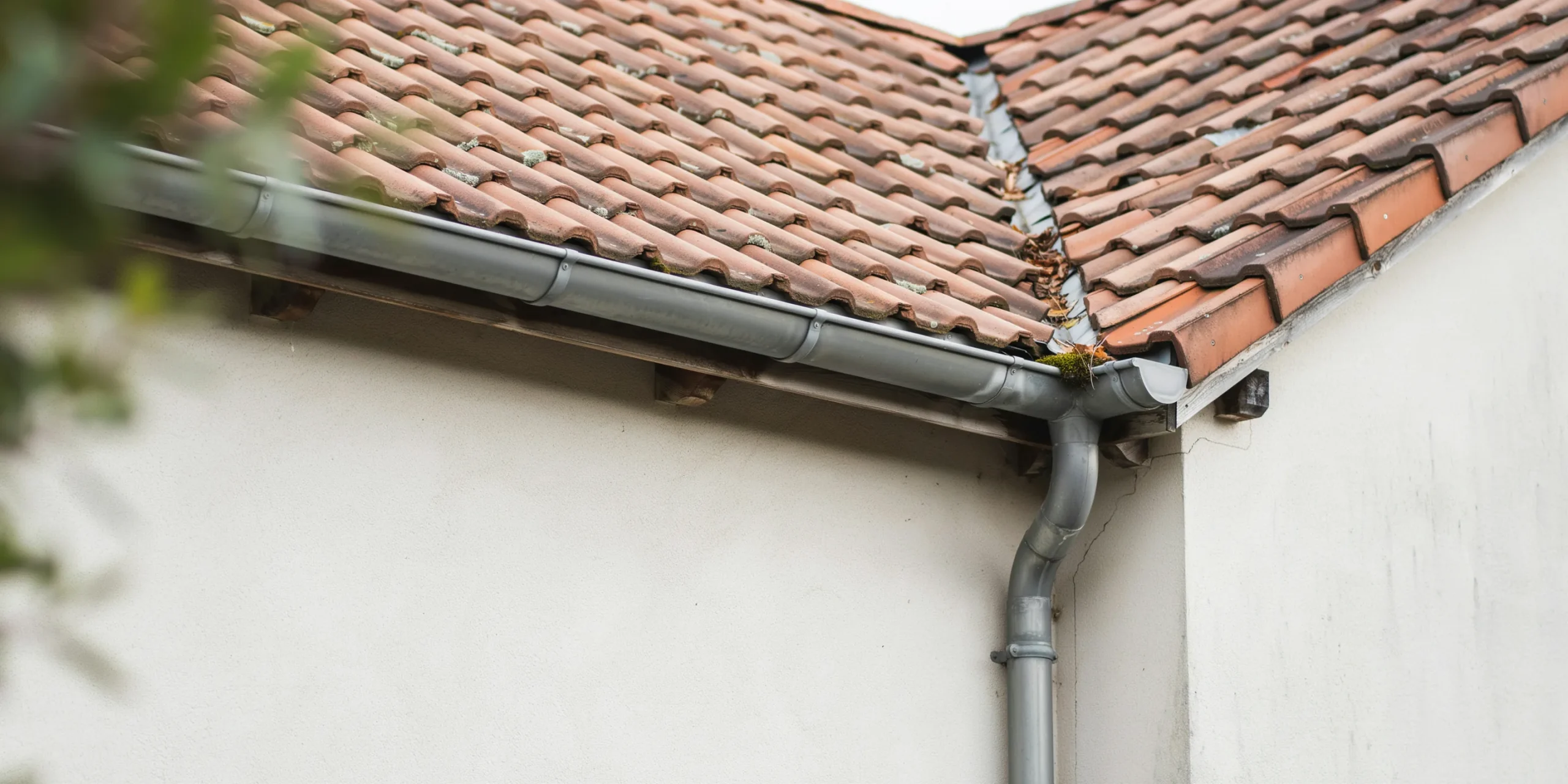 Architectural details of a sloped roof with rainwater management features