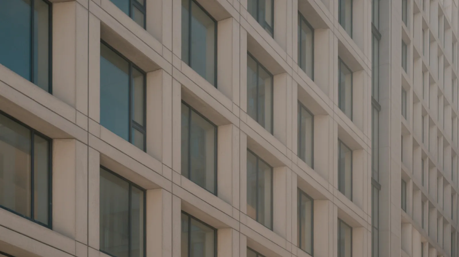 Repeating window bays on a concrete and glass facade, the kind of repeated geometry Smart Blocks detects in an AutoCAD drawing