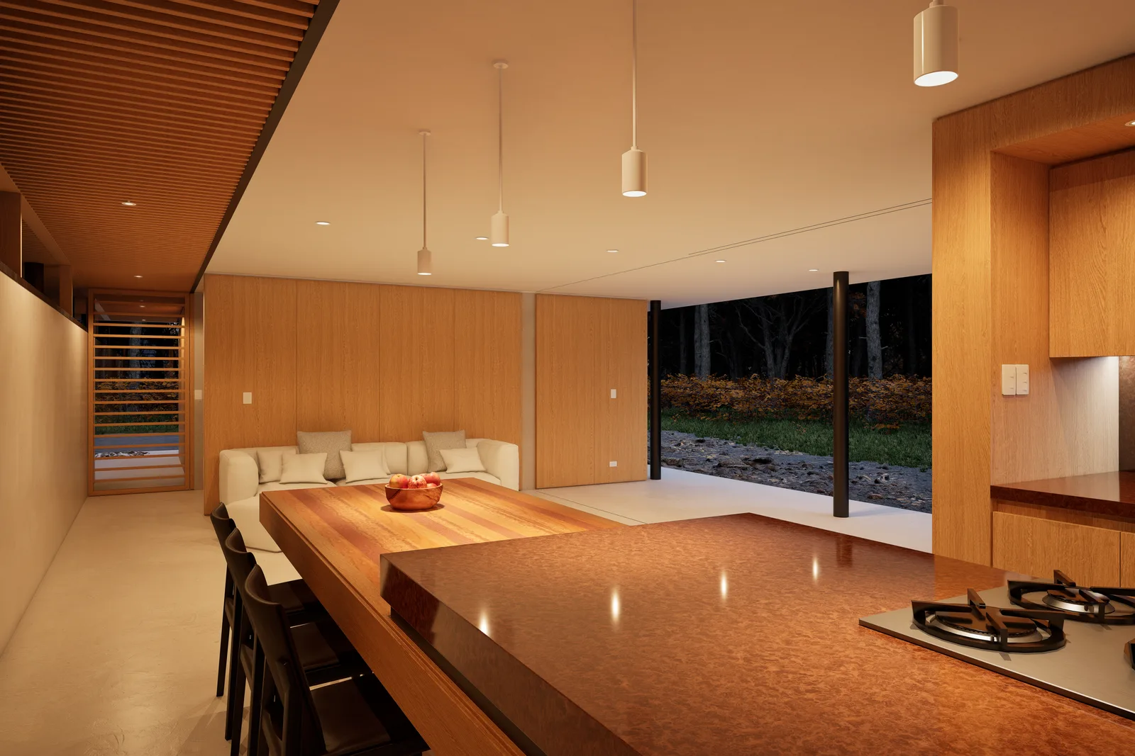 Kitchen and living space in one timber lined volume, with no hallway and a glazed wall opening to the garden